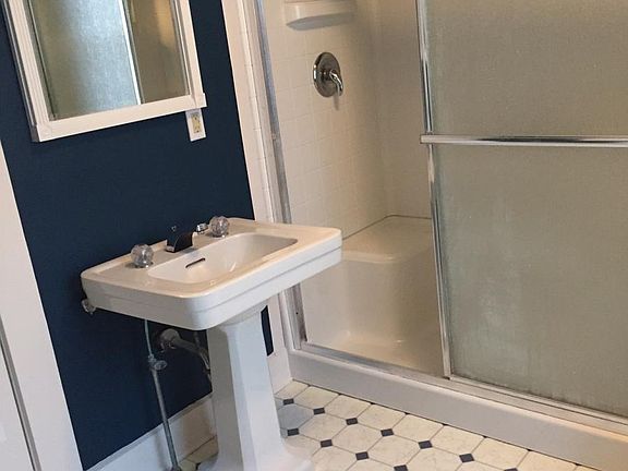 Bathroom with walk-in shower. Has 1 large closet and 1 smaller closet.