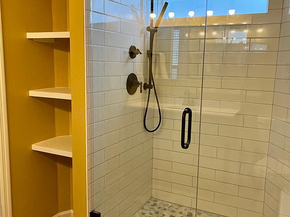 Walk in shower in larger bedroom.