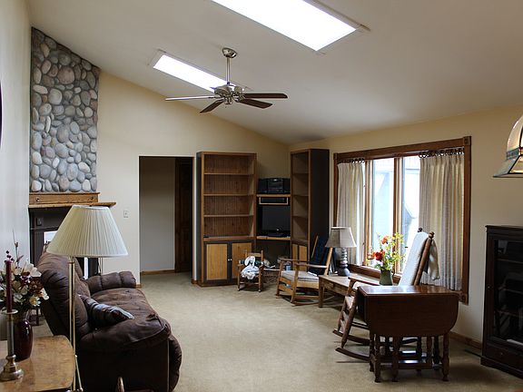 This vaulted living room with skylights faces the backyard.