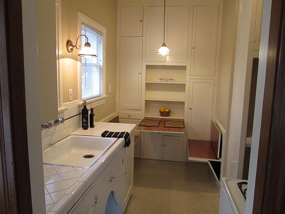 Vintage kitchen with seating and table that can be recessed into the walls for added floor space.