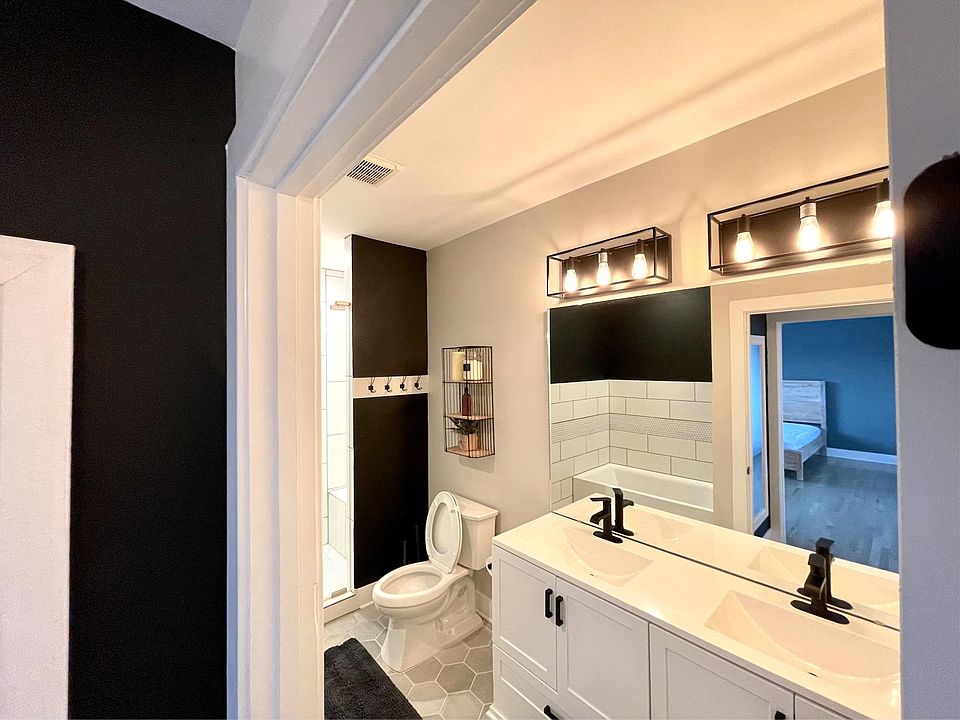 The master bathroom has a deep soaking tub, a large walk-in shower, and double vanities.
