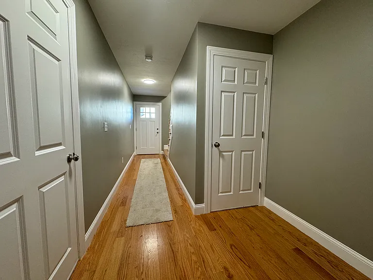main entry hallway (shows garage entry door, front entrance, and basement access)