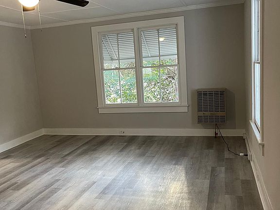 Living room with new natural gas heater which can heat up to 900 sf, has thermostat and a blower.