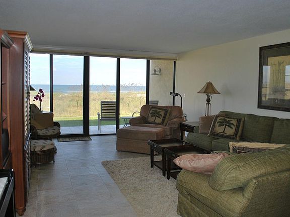 Living room opens to patio and beach