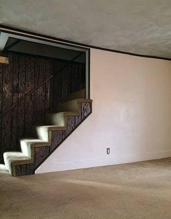 Cozy, living room area with steps going to upstairs 