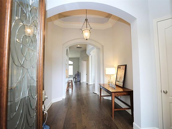 Enter through the wood and lead glass door to newer wood floors throughout the home! Arched entry, front hall closet for coats and spacious foyer and 12' ceilings.