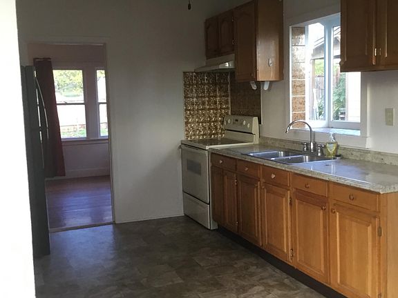 Kitchen and living room in distance.