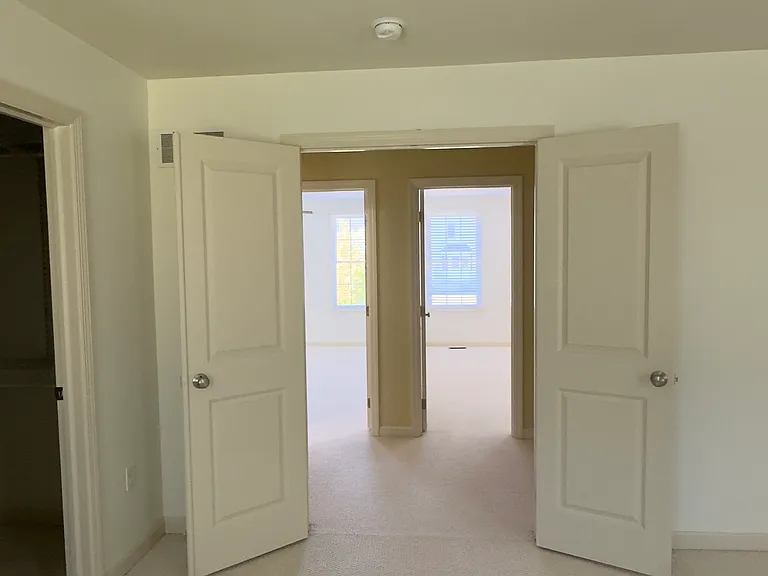 Primary bedroom double doors to third floor landing.