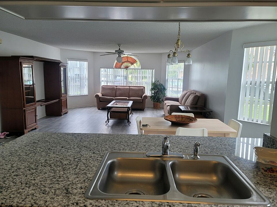 Living room, dining room view from the kitchen. Brand new porcelain tile floors throughout.