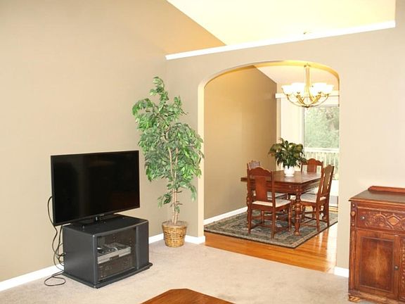 Archway between livingroom and dining room allow light to shine thought the home.