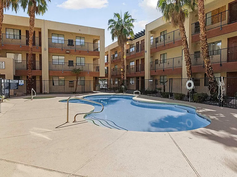 Enjoy a refreshing escape in this beautiful apartment community with a sparkling pool and lush palm trees.