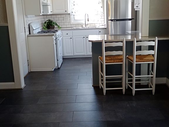 Dining room into the kitchen with new laminate flooring