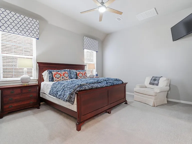 Expansive primary bedroom downstairs with room for a sitting area.