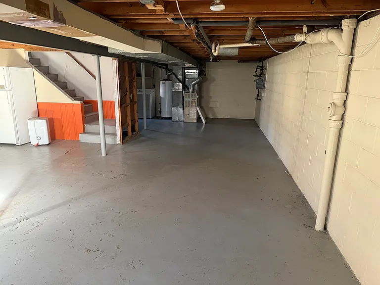 basement showing HVAC and hot water heater