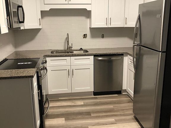 Newly renovated kitchen complete with shaker cabinets, countertops, and new stainless steel appliances.