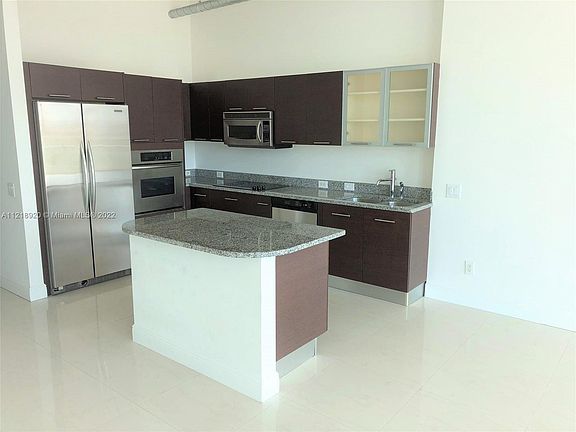 Spacious Open Kitchen with Stainless Steel Appliances and Plenty of Cabinet Space