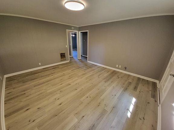 Living Room has new floors, paint, and light fixtures.