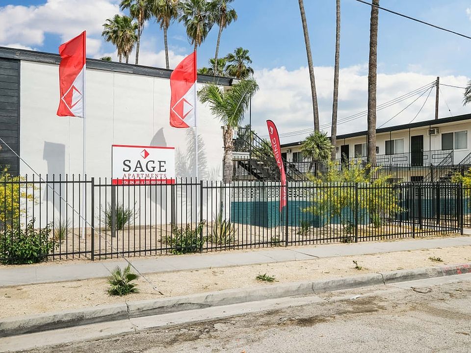 Sage I a building with a fence and flags in front of it side exterior view of building