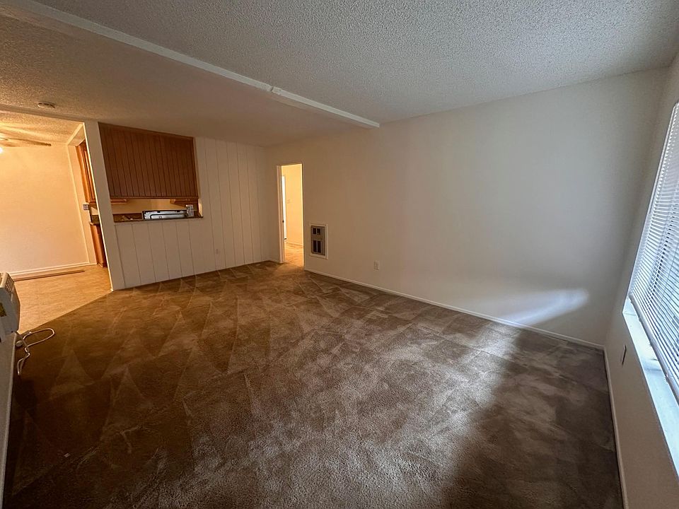 The front room. Doorway on right into the bedroom. toward left dining & kitchen area