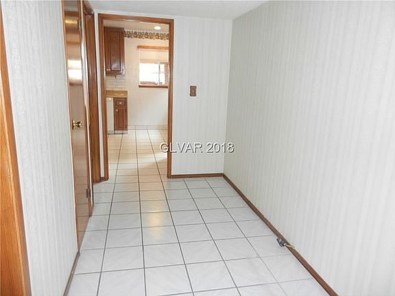 Hallway looking into kitchen w/half bath on the lrft