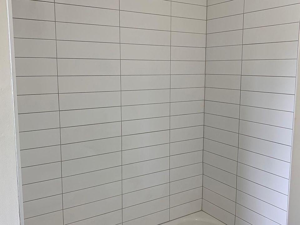 Modern White Tile Bathroom with Moen Fixtures