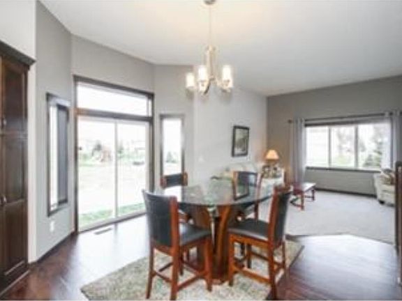 Dining room shows off the bay window and patio doors