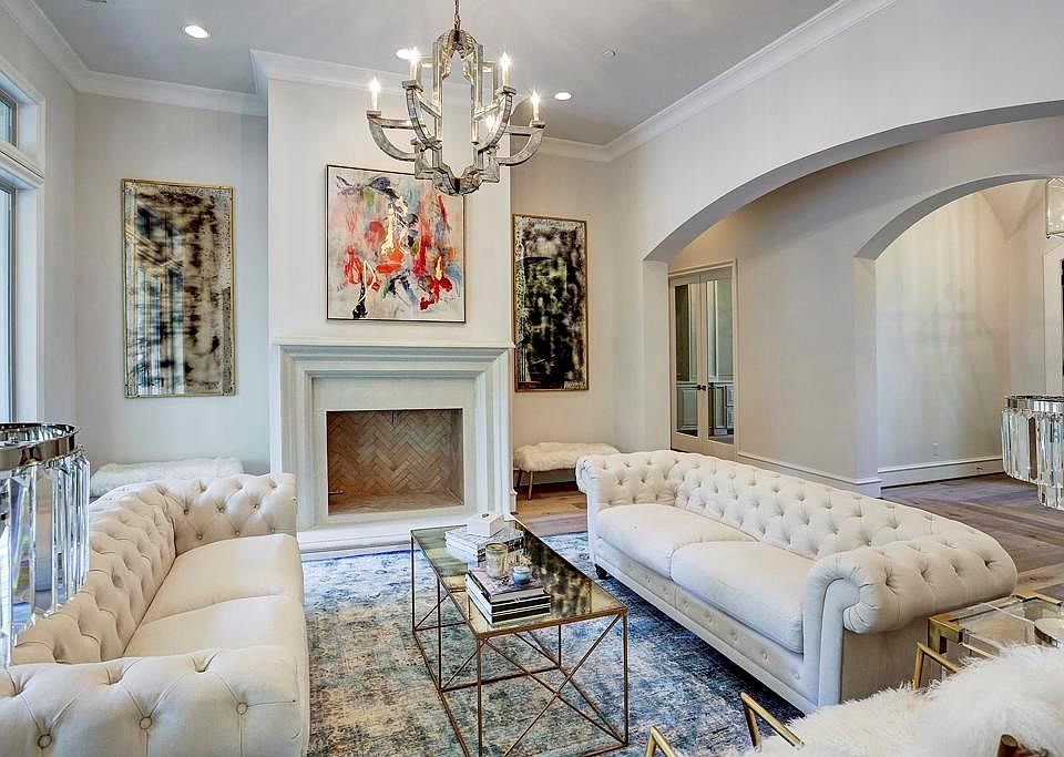 Inside the horseshoe of quiet, wooded Valley Forge resides this elegant, cream stucco five bedroom home by Randy Rau Custom Home