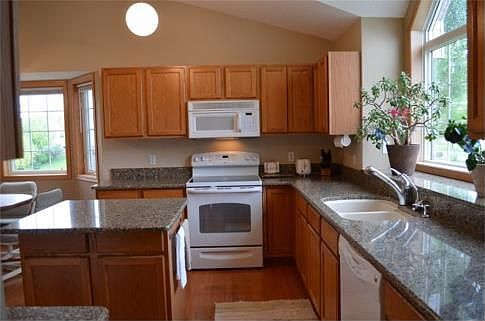 The chef in your family will enjoy working in this spacious kitchen that features Cambria counters, wood floors and a great center island.