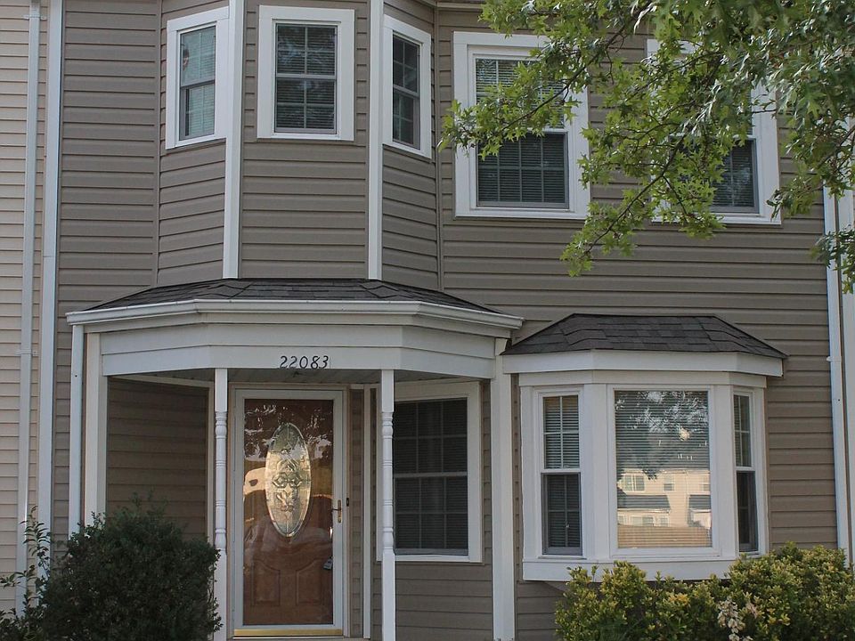 Exterior view. Unit faces community green area across the parking lot.