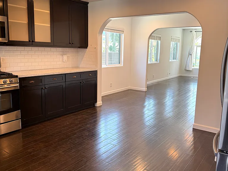 Kitchen with abundant storage, stainless steel appliances, dimmable recessed LED lighting, and views of the backyard and patio