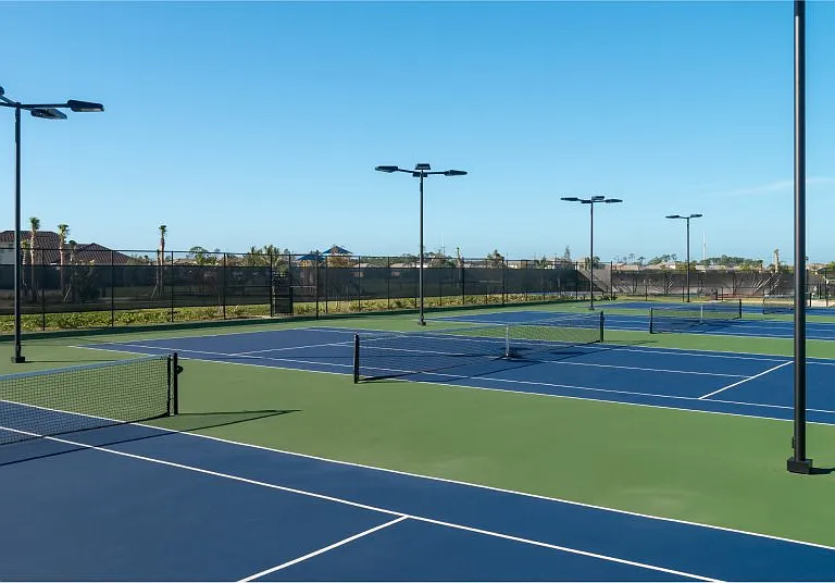 The well-lit, outdoor tennis courts are available for residential use in the day and night.