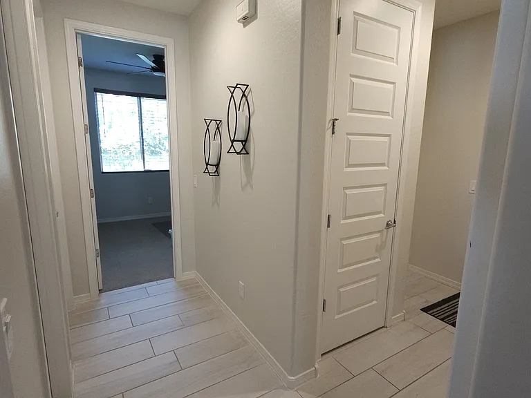 Hallway to Bedroom 4 Bathroom3 and laundry, Exit to garage on the right