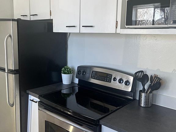 Kitchen features stainless steel appliances.