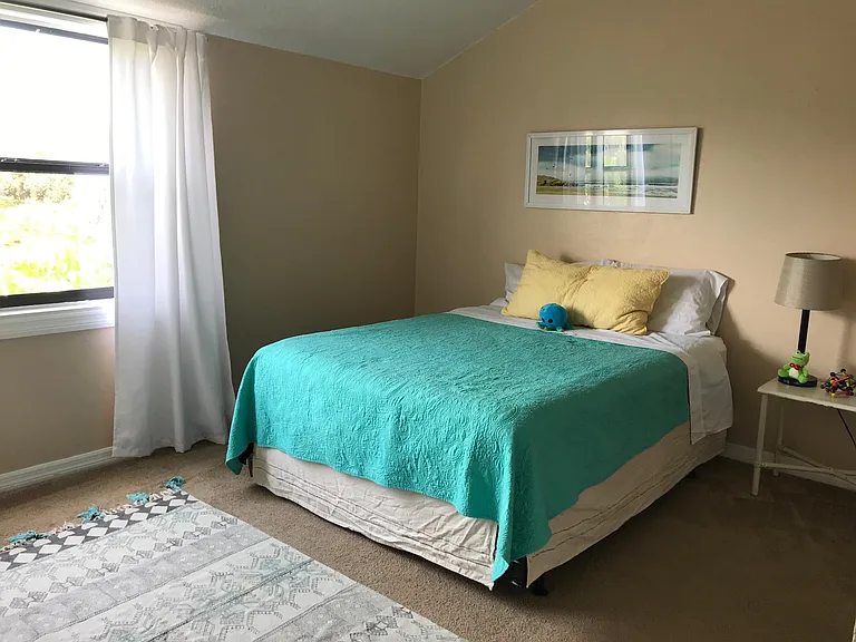 Large (12x14 ft) South facing bedroom with vaulted ceilings and ceiling fan.