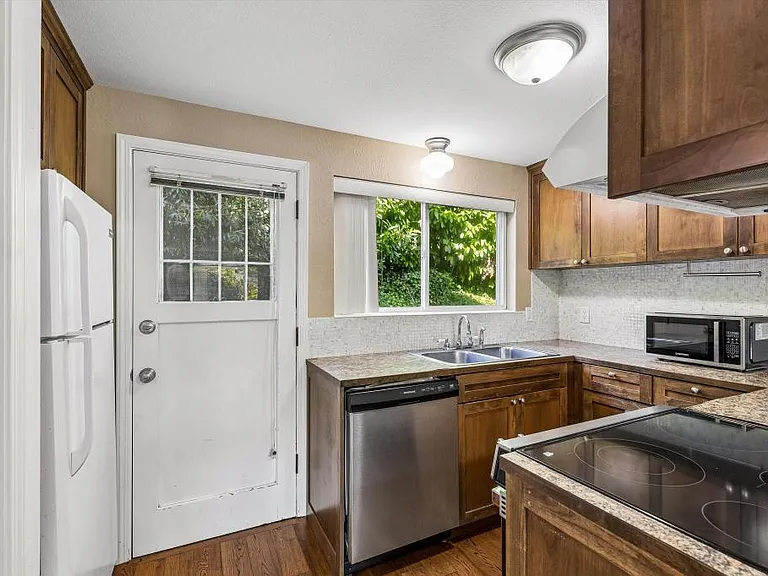 Kitchen w/ entry to back yard space