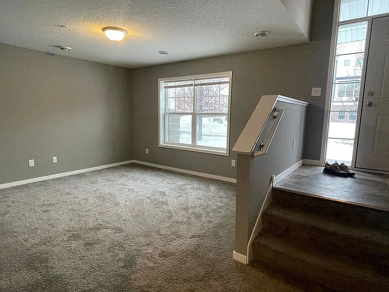 Introducing a spacious and inviting living area at LS Capital Group, featuring plush carpeting and abundant natural light. This versatile space is perfect for relaxing and entertaining. Don't miss outAaaschedule your tour today!