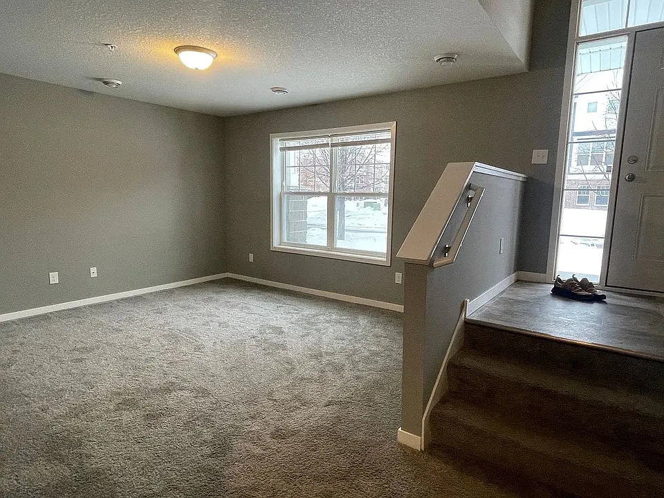 Introducing a spacious and inviting living area at LS Capital Group, featuring plush carpeting and abundant natural light. This versatile space is perfect for relaxing and entertaining. Don't miss out! Schedule your tour today!