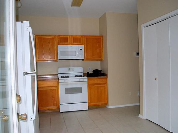 View from the back door into the kitchen, Washer and dryer closet on the right.