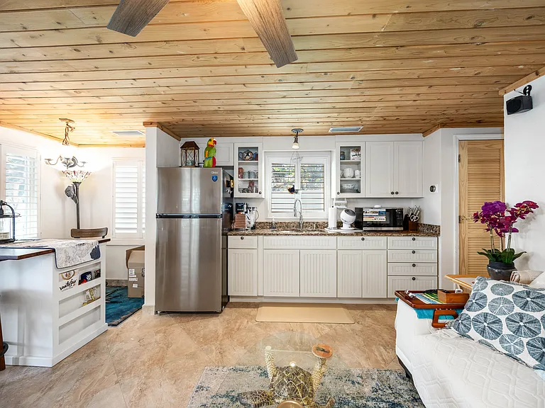 OWNERS FIRST FLOOR KITCHEN AREA, DINING BAR TOP AND LIVING AREA. ALL TOUNGUE AND GROOVE CEDAR CEILING THROUGHOUT