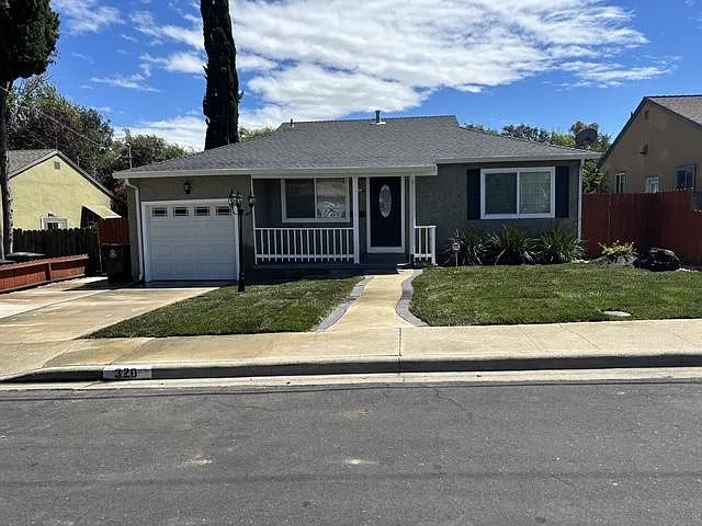 Front View of home, with newly installed sod lawn with automatic sprinklers.