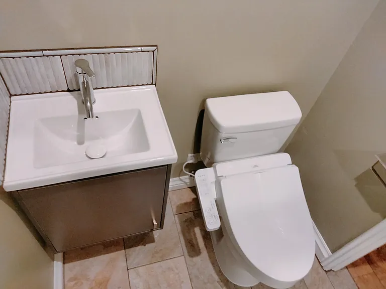 Sink w tile backsplash toilet w bidet!