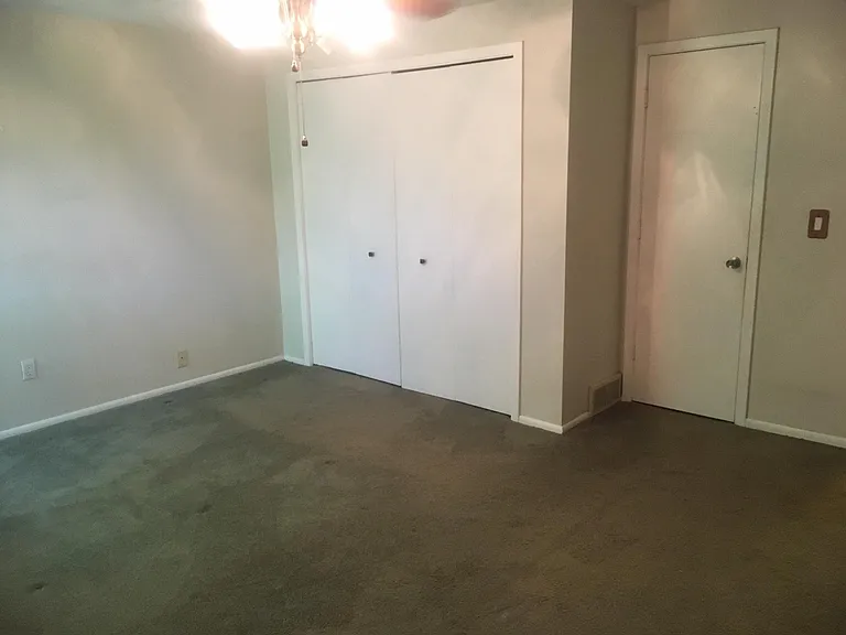 Master bedroom closet and entry into full bath