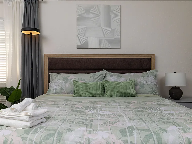 Cozy bedroom with a king bed and nature-inspired decor.