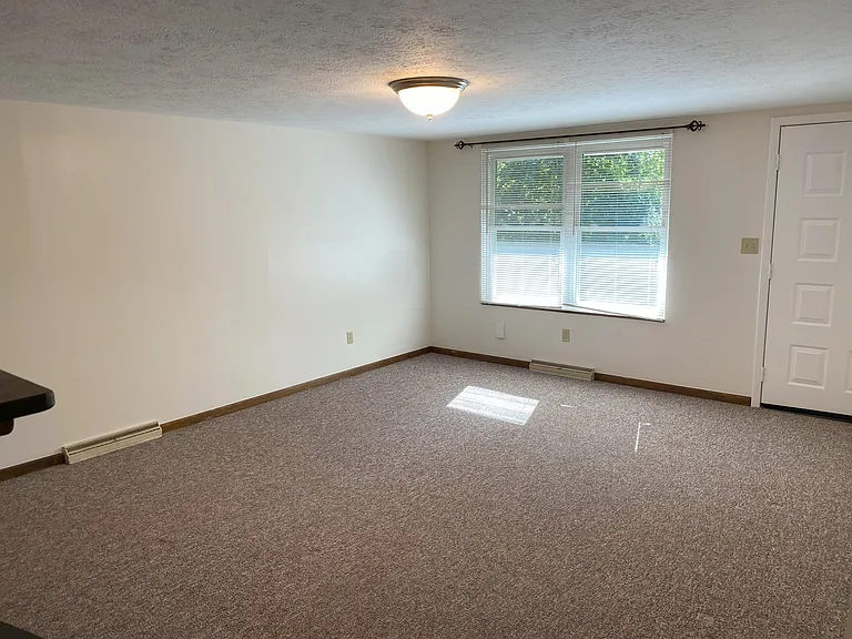 Living room and door to the backside of unit.