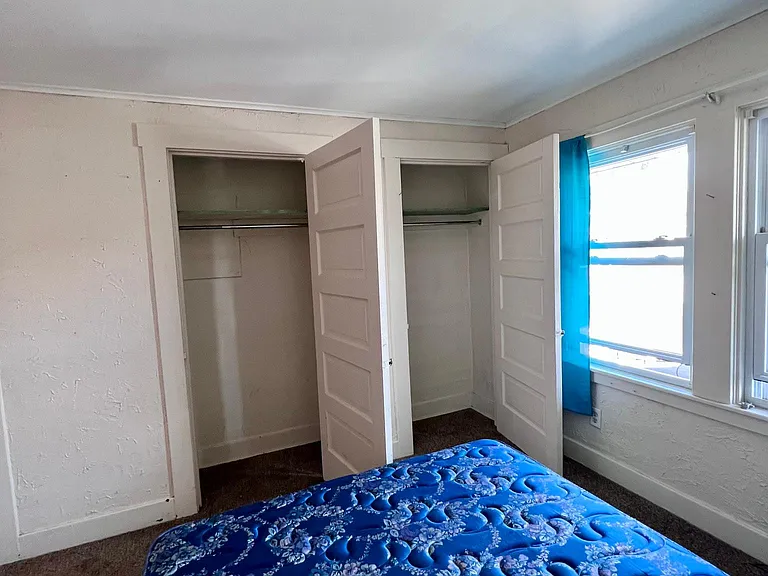 back bedroom (faces back porch and side driveway/alley)