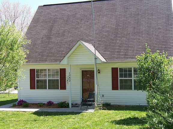 front of house showing maturing trees