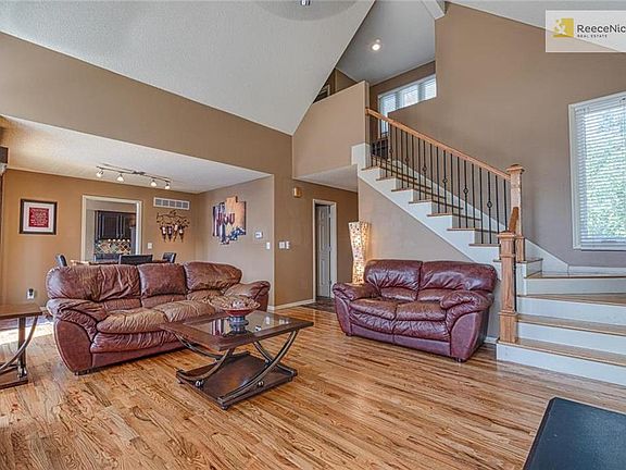 Staircase has hardwood steps and iron spindles.
