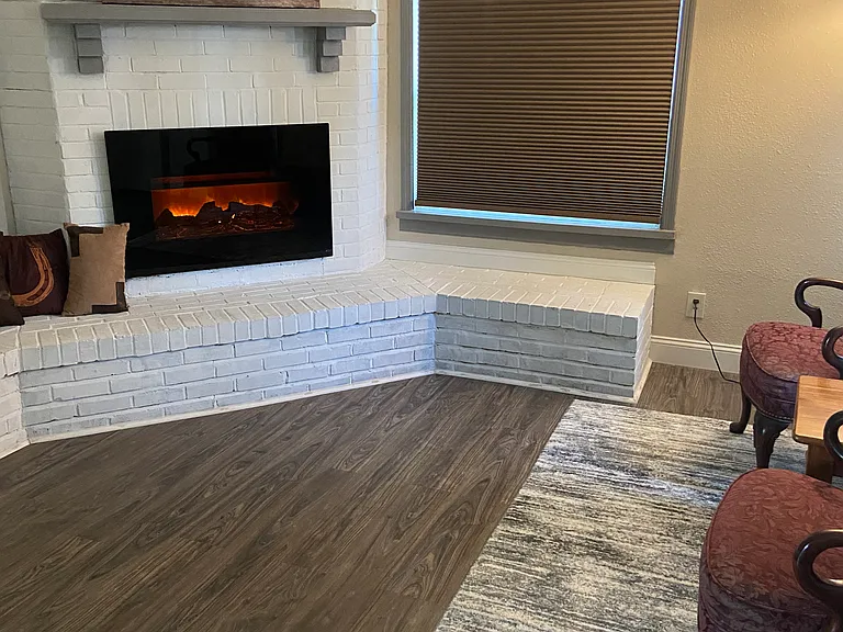 Spacious living room with an electric fireplace.