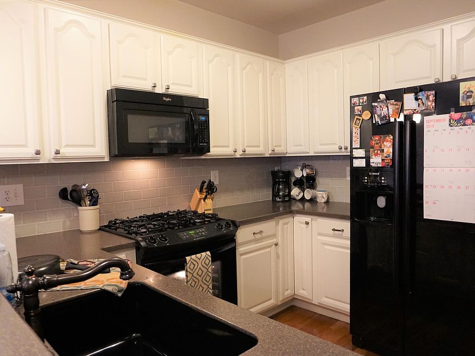 Lovely kitchen with newly painted white cabinets and new fridge