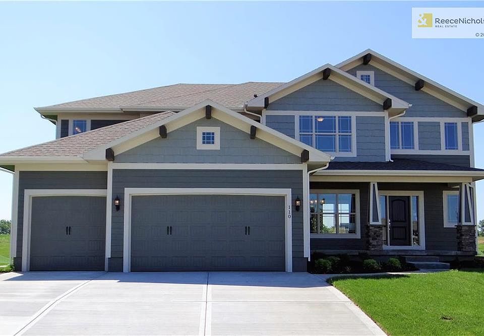 Welcome to 110 SE Shores Court in The Shores at Chapman Farms. This Bristol Ridge II plan has 5 bedrooms, 4 bathrooms and a sitting room in the Master Suite with a fireplace.